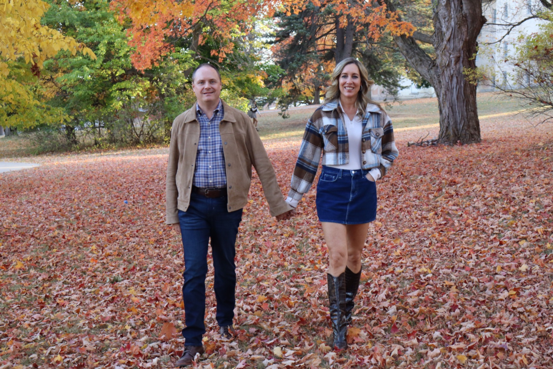 Couple walking through autumn leaves by Patrick’s Photography